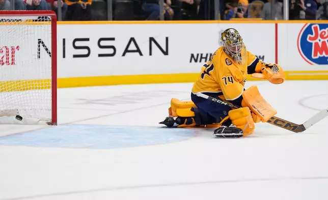 Nashville Predators goaltender Juuse Saros (74) looks back as a goal is scored by Montreal Canadiens right wing Ivan Demidov (not pictured) during the first period of an NHL hockey game Saturday, March 28, 2026, in Nashville, Tenn. (AP Photo/George Walker IV)