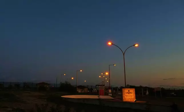 FILE - The gate of the U.K.'s RAF Akrotiri air base at sunset after it was struck by a drone earlier in the morning near Limassol, Cyprus, March 2, 2026. (AP Photo/Petros Karadjias, File)