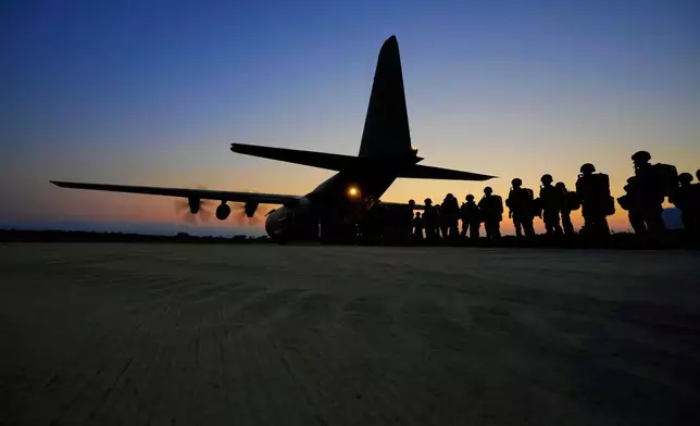 FILE - British paratroopers with the 16th Air Assault Brigade line up to board a C-130 transport aircraft at RAF Akrotiri air base in Cyprus for an airdrop over Jordan as part of a joint exercise with Jordanian soldiers, June 23, 2021. (AP Photo/Petros Karadjias, File)
