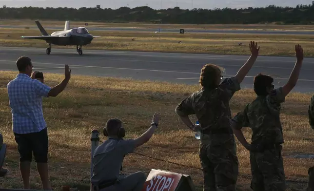 FILE - British soldiers wave to the F-35B aircraft after landing at Akrotiri Royal air forces base near city of Limassol, Cyprus, May 21, 2019. (AP Photo/Petros Karadjias, File)
