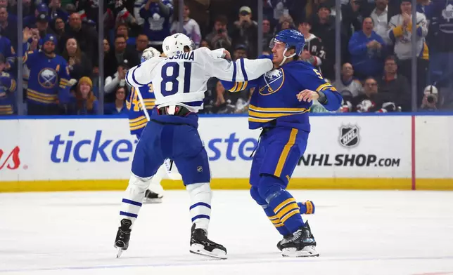 Toronto Maple Leafs center Dakota Joshua (81) and Buffalo Sabres defenseman Luke Schenn (5) fight during the first period of an NHL hockey game Saturday, March 14, 2026, in Buffalo, N.Y. (AP Photo/Jeffrey T. Barnes)