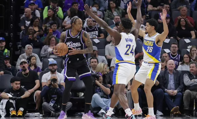 Sacramento Kings guard DeMar DeRozan (10) looks to pass as he is double teamed by Indiana Pacers guard Kobe Brown (24) and Indiana Pacers guard Ben Sheppard (26) during the first half of an NBA basketball game Tuesday, March 10, 2026, in Sacramento, Calif. (AP Photo/Scott Marshall)