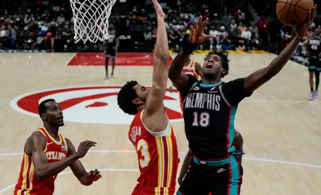 Memphis Grizzlies forward Olivier-Maxence Prosper (18) shoots against against the Atlanta Hawks during the second half of an NBA basketball game, Monday, March 23, 2026, in Atlanta. (AP Photo/Mike Stewart)