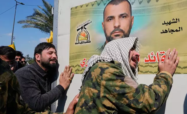 Relatives grieve during a funeral of a fighter with the Kataib Hezbollah, who was killed in a U.S. airstrike, in Baghdad, Iraq, Monday, March 2, 2026. (AP Photo/Hadi Mizban)