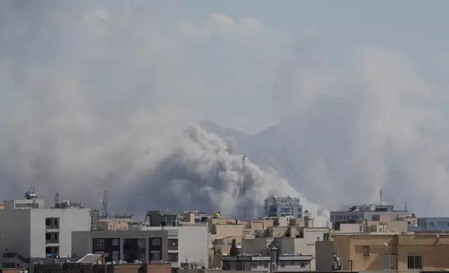 Smoke rises up after a strike in Tehran, Iran, Sunday, March 1, 2026. (AP Photo/Vahid Salemi)