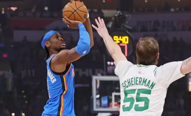 Oklahoma City Thunder guard Shai Gilgeous-Alexander, left, looks to shoot against Boston Celtics guard Baylor Scheierman (55) during the first half of an NBA basketball game, Thursday, March 12, 2026, in Oklahoma City. (AP Photo/Nate Billings)