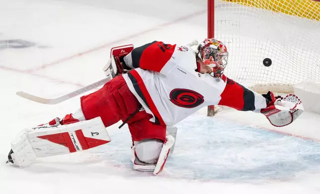 Carolina Hurricanes goaltender Frederik Andersen (31) is scored on by Montreal Canadiens' Cole Caufield during the second period of an NHL hockey game in Montreal on Tuesday, March 24, 2026. (Christinne Muschi/The Canadian Press via AP)