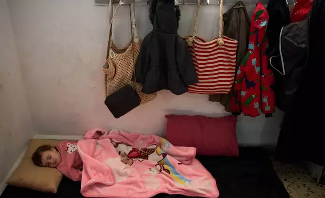 Malika Rabaa, 1, who fled with her family following Israeli strikes in southern Lebanon, sleeps in a school used as a shelter in Beirut, Lebanon, Wednesday, March 25, 2026. (AP Photo/Emilio Morenatti)