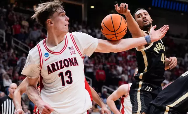 Arizona center Motiejus Krivas (13) reaches for a rebound next to Purdue forward Trey Kaufman-Renn (4) during the second half in the Elite Eight of the NCAA college basketball tournament, Saturday, March 28, 2026, in San Jose, Calif. (AP Photo/Godofredo A. Vásquez)