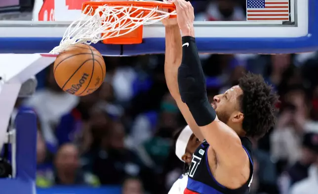 Detroit Pistons guard Cade Cunningham (2) dunks the ball against the Memphis Grizzlies during the first half of an NBA basketball game Friday, March 13, 2026, in Detroit. (AP Photo/Duane Burleson)