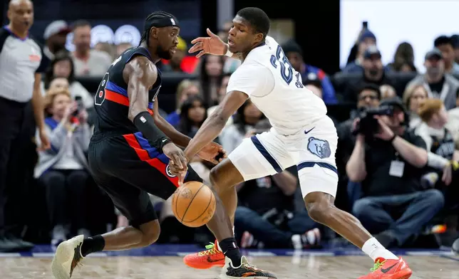 Memphis Grizzlies forward Cedric Coward (23) steals the ball from Detroit Pistons guard Caris LeVert (8) during the first half of an NBA basketball game Friday, March 13, 2026, in Detroit. (AP Photo/Duane Burleson)
