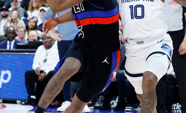 Detroit Pistons forward Ronald Holland II (5) drives to the basket past Memphis Grizzlies guard Javon Small (10) during the second half of an NBA basketball game Friday, March 13, 2026, in Detroit. (AP Photo/Duane Burleson)