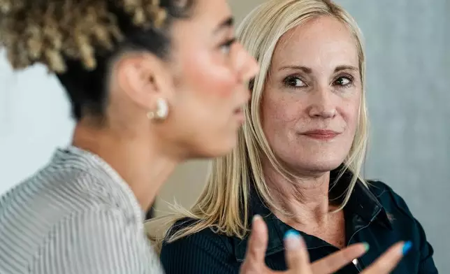 Kristin Lemkau, CEO, J.P. Morgan Wealth Management, listens to Ally Love, Peloton Instructor + VP, Instructor Strategy &amp; Development, during an interview after taking part in a Pro Athlete event at JPMorganChase headquarters in New York, Wednesday, March 18, 2026. (AP Photo/Eduardo Munoz Alvarez)