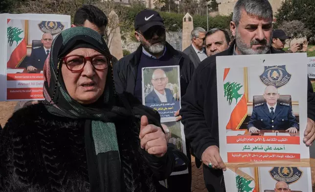 Salwa Hazimeh, left, the wife of retired Lebanese officer Ahmed Shukr, speaks during a gathering outside the headquarters of the U.N. Economic and Social Commission for Western Asia, ESCWA, in Beirut, Lebanon, Friday, Feb. 13, 2026. (AP Photo/Bilal Hussein)