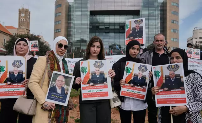 Relatives and friends of retired Lebanese officer Ahmed Shukr, hold posters of him during a gathering outside the headquarters of the U.N. Economic and Social Commission for Western Asia, ESCWA, in Beirut, Lebanon, Friday, Feb. 13, 2026. (AP Photo/Bilal Hussein)