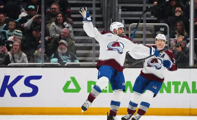 Colorado Avalanche center Nazem Kadri, left, celebrates scoring against the Seattle Kraken with center Nathan MacKinnon, right, during the second period of an NHL hockey game Thursday, March 12, 2026, in Seattle. (AP Photo/Lindsey Wasson)
