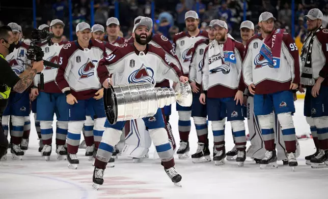 FILE - Colorado Avalanche center Nazem Kadri (91) lifts the Stanley Cup after the team defeated the Tampa Bay Lightning in Game 6 of the NHL hockey Stanley Cup Finals, June 26, 2022, in Tampa, Fla. (AP Photo/Phelan M. Ebenhack, File)