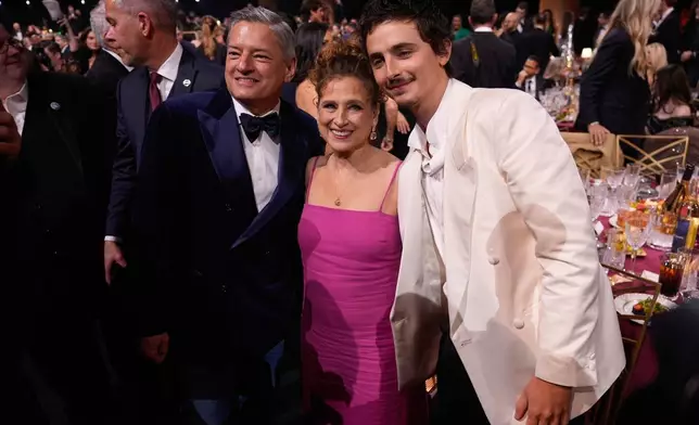 Ted Sarandos, from left, Nicole Flender, and Timothee Chalamet are seen in the audience during the 32nd Annual Actor Awards on Sunday, March 1, 2026, at the Shrine Auditorium and Expo Hall in Los Angeles. (AP Photo/Chris Pizzello)
