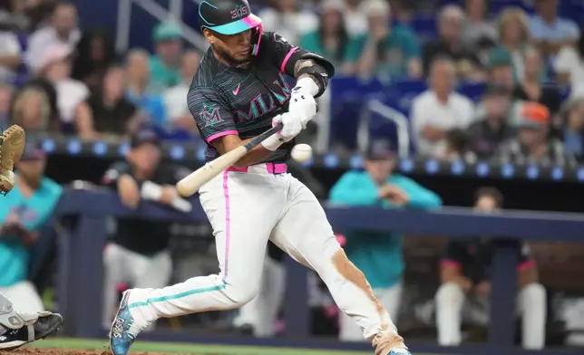 Miami Marlins' Agustín Ramírez hits. Single during the fifth inning of a baseball game against the Colorado Rockies, Saturday, March 28, 2026, in Miami. (AP Photo/Lynne Sladky)