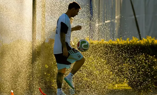 Argentina's Lionel Messi warms up during a training session ahead of an international friendly match against Mauritania, at the Argentina Soccer Association in Buenos Aires, Argentina, Wednesday, March 25, 2026. (AP Photo/Gustavo Garello)
