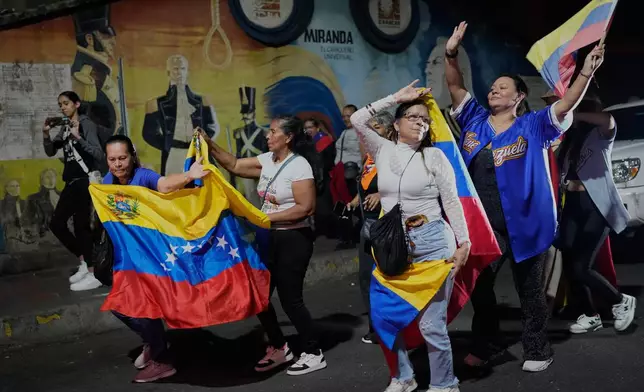 Venezuela fans celebrate their country's win against the United States in the championship match of the World Baseball Classic a day prior, in Caracas, Venezuela, Wednesday, March 18, 2026. (AP Photo/Ariana Cubillos)