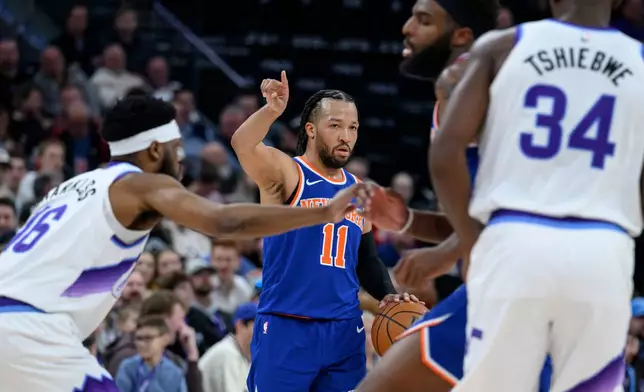 New York Knicks guard Jalen Brunson (11) sets the play during the first half of an NBA basketball game against the Utah Jazz, Wednesday, March 11, 2026, in Salt Lake City. (AP Photo/Tyler Tate)