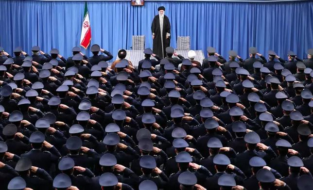 FILE - In this photo released by an official website of the Office of the Iranian Supreme Leader, Supreme Leader Ayatollah Ali Khamenei stands as the army's air force and air defense staff salute in Tehran, Iran, Feb. 8, 2020. A portrait of the late revolutionary founder Ayatollah Khomeini hangs in the background. (Office of the Iranian Supreme Leader via AP, File)