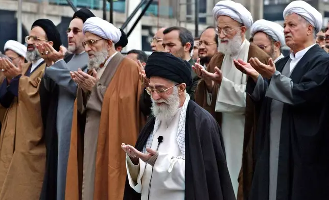 FILE - Iranian Supreme Leader Ayatollah Ali Khamenei, foreground, leads an Eid al-Fitr prayer, marking the end of Muslims' holy fasting month of Ramadan, in Tehran, Iran, Nov. 14, 2004. (AP Photo/Vahid Salemi, File)