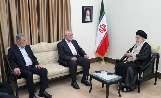 FILE - In this photo released by the office of the Iranian supreme leader, Supreme Leader Ayatollah Ali Khamenei, right, speaks with Hamas chief Ismail Haniyeh, center, and the leader of the Palestinian Islamic Jihad group Ziad Nakhaleh in their meeting in Tehran, Iran, July 30, 2024. A portrait of the late Iranian revolutionary founder Ayatollah Khomeini hangs on the wall. (Office of the Iranian Supreme Leader via AP, File)