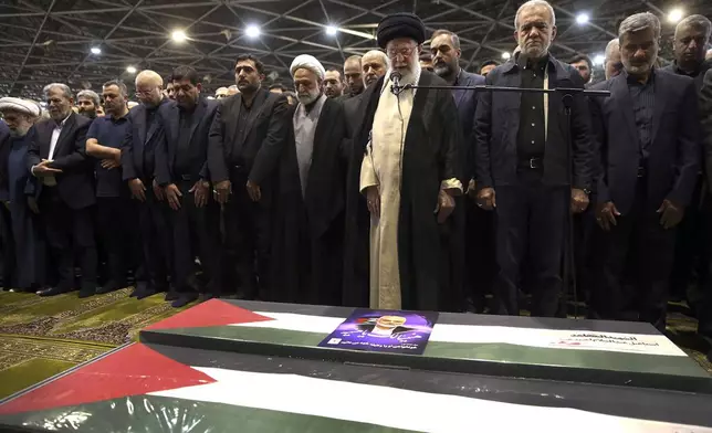 FILE - In this photo released by the official website of the office of the Iranian supreme leader, Supreme Leader Ayatollah Ali Khamenei, third right, leads a prayer over the coffins of Hamas leader Ismail Haniyeh and his bodyguard who were killed in an assassination blamed on Israel on Wednesday, during their funeral ceremony at the Tehran University campus, in Tehran, Iran, Aug. 1, 2024. (Office of the Iranian Supreme Leader via AP, File)