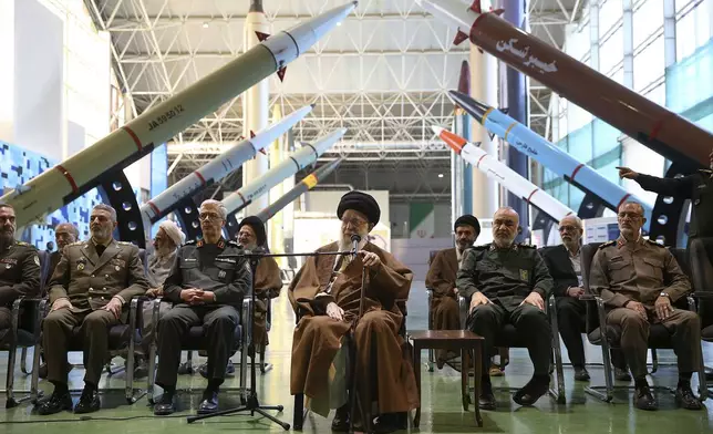 FILE - In this photo released by an official website of the office of the Iranian supreme leader, Supreme Leader Ayatollah Ali Khamenei, center, accompanied by the armed forces commanders, visits an exhibition of the Revolutionary Guard's aerospace achievements, in Iran, Nov. 19, 2023. (Office of the Iranian Supreme Leader via AP, File)