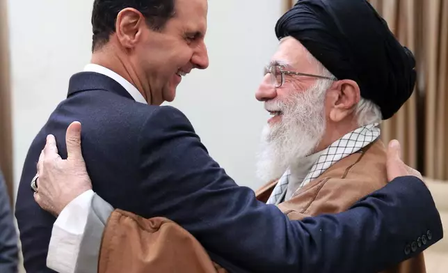 FILE - In this photo released by an official website of the office of the Iranian supreme leader, Supreme Leader Ayatollah Ali Khamenei, right, welcomes Syrian President Bashar Assad for their meeting in Tehran, Iran, Feb. 25, 2019. (Office of the Iranian Supreme Leader via AP, File)
