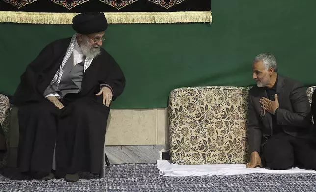 FILE - In this photo released by the official website of the office of the Iranian supreme leader, commander of the Iran's Revolutionary Guard expeditionary Quds Force, Gen. Qassem Soleimani, right, greets Supreme Leader Ayatollah Ali Khamenei while attending a religious ceremony, in Tehran, Iran, March 27, 2015. (Office of the Iranian Supreme Leader via AP, File)