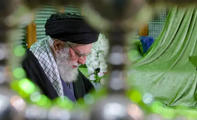 FILE - In this photo released by an official website of the office of the Iranian supreme leader, Supreme Leader Ayatollah Ali Khamenei prays at the grave of the late revolutionary founder Ayatollah Khomeini, commemorating the 47th anniversary of his return from exile during the 1979 Islamic Revolution, just outside Tehran, Iran, Jan. 31, 2026. (Office of the Iranian Supreme Leader via AP, File)
