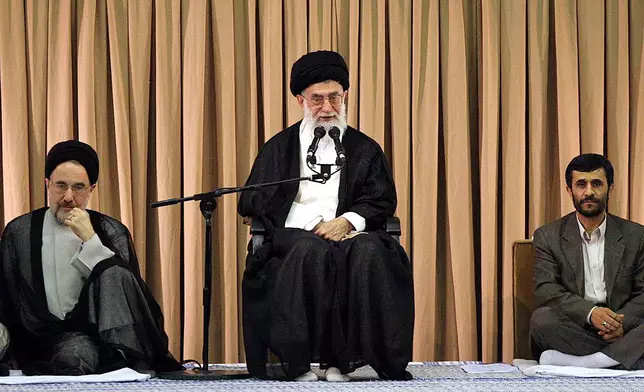 FILE - Iran's Supreme Leader Ayatollah Ali Khamenei, center, speaks after giving his official seal of approval to President Mahmoud Ahmadinejad, right, as former President Mohammad Khatami, listens, in a ceremony in Tehran, Aug. 3, 2005. (AP Photo/Hasan Sarbakhshian, File)