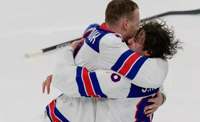 United States' Jack Hughes (86) celebrates with United States' Brady Tkachuk (7) after scoring the game-winning goal against Canada in sudden death overtime during the men's ice hockey gold medal game at the 2026 Winter Olympics, in Milan, Italy, Sunday, Feb. 22, 2026. (AP Photo/Luca Bruno)