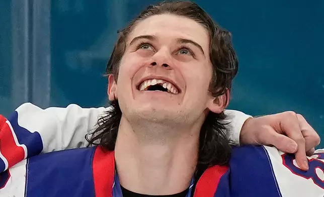 United States' Jack Hughes (86) reacts after receiving his gold medal after the USA defeated Canada in the men's ice hockey gold medal game at the 2026 Winter Olympics, in Milan, Italy, Sunday, Feb. 22, 2026. (AP Photo/Luca Bruno)