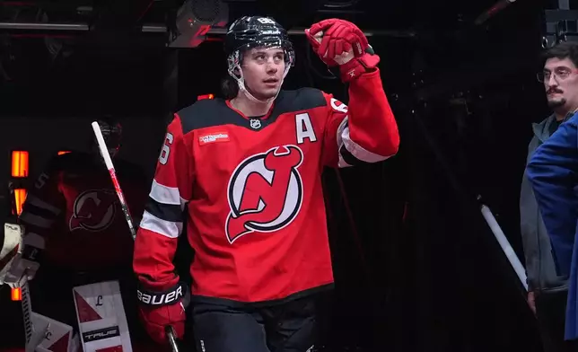 New Jersey Devils' Jack Hughes (86) walks toward the ice to warm up before an NHL hockey game against the Buffalo Sabres Wednesday, Feb. 25, 2026, in Newark, N.J. (AP Photo/Frank Franklin II)