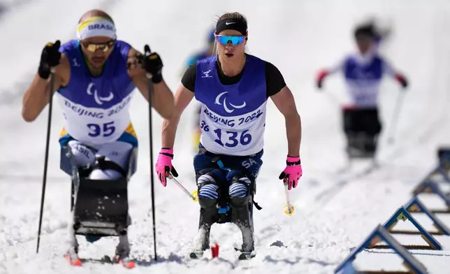 FILE - Oksana Masters, center, of the U.S. competes during a ceremony for the women's middle distance sitting event of para cross country skiing at the 2022 Winter Paralympics, Saturday, March 12, 2022, in Zhangjiakou, China. Masters took the silver medal. (AP Photo/Shuji Kajiyama, file)