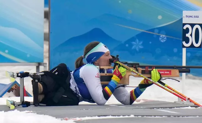 FILE - Anja Wicker of Germany shoots during the women's individual sitting event of para biathlon at the 2022 Winter Paralympics, Friday, March 11, 2022, in Zhangjiakou, China. (AP Photo/Shuji Kajiyama, file)