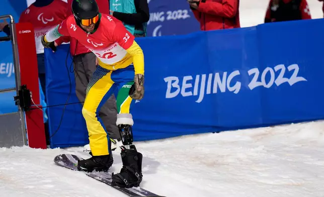 FILE - A Brazilan athlete starts during a training session ahead of Friday's para snowboard event at the 2022 Winter Paralympics, Thursday, March 10, 2022, in Zhangjiakou, China. (AP Photo/Shuji Kajiama, file)