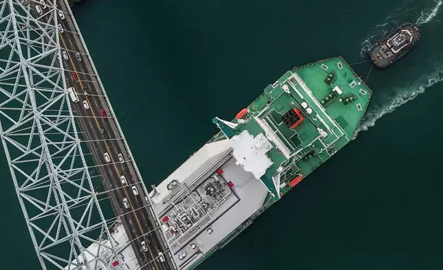 A liquefied natural gas carrier sails under Las Americas Bridge through the Panama Canal in Panama City, Tuesday, March 24, 2026. (AP Photo/Matias Delacroix)