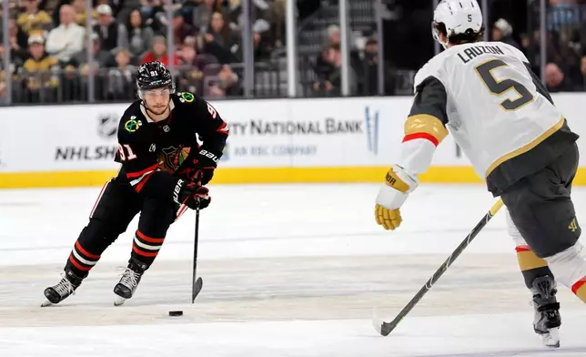 Chicago Blackhawks center Frank Nazar (91) skates against Vegas Golden Knights defenseman Jeremy Lauzon (5) during the first period of an NHL hockey game Saturday, March 14, 2026, in Las Vegas. (AP Photo/Steve Marcus)