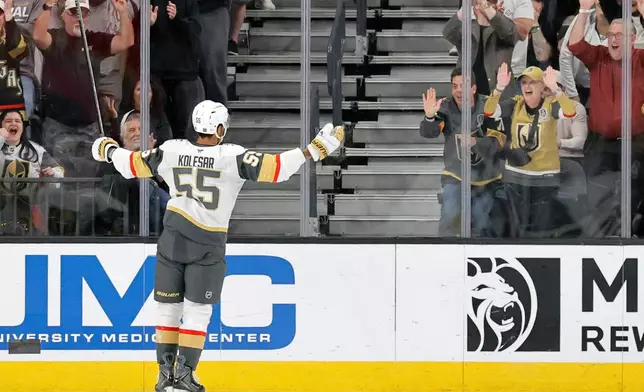 Vegas Golden Knights right wing Keegan Kolesar (55) faces fans after scoring against the Chicago Blackhawks during the first period of an NHL hockey game Saturday, March 14, 2026, in Las Vegas. (AP Photo/Steve Marcus)