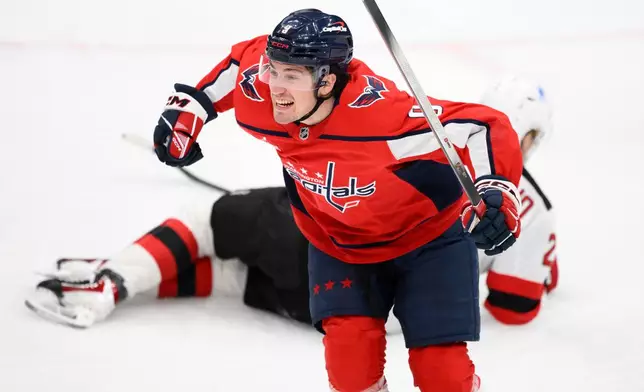 Washington Capitals right wing Ryan Leonard (9) celebrates his goal during the first period of an NHL hockey game against the New Jersey Devils, Friday, March 20, 2026, in Washington. (AP Photo/Nick Wass)