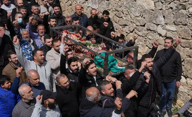 Mourners carry the coffin of Jawad Younes, 11, who was killed on Friday in an Israeli airstrike, as they shout slogans during a funeral procession in Saksakiyeh village, south Lebanon, Saturday, March 28, 2026. (AP Photo/Hussein Malla)