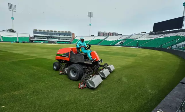 A groundsman works at the at the Gaddafi Stadium in preparations for upcoming Pakistan's premier domestic T20 the Pakistan Super League, which will take place in empty stadiums due to the recent spike in oil prices, in Lahore, Pakistan, Tuesday, March 24, 2026. (AP Photo/K.M. Chaudary)