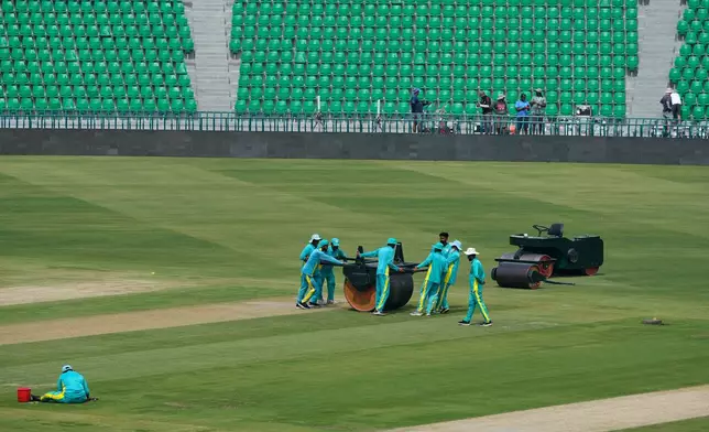 Groundsmen work at the at the Gaddafi Stadium in preparations for upcoming Pakistan's premier domestic T20 the Pakistan Super League, which will take place in empty stadiums due to the recent spike in oil prices, in Lahore, Pakistan, Tuesday, March 24, 2026. (AP Photo/K.M. Chaudary)