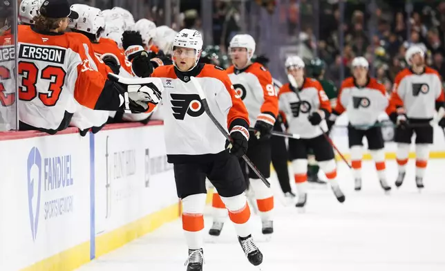 Philadelphia Flyers defenseman Emil Andrae (36) celebrates at the bench after scoring during the first period of an NHL hockey game against the Minnesota Wild Thursday, March 12, 2026, in St. Paul, Minn. (AP Photo/Ellen Schmidt)