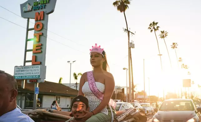 Lowriders cruise at the 6th Annual Lady Lowrider Cruise Night in celebration of International Women's Day in Pasadena, Calif., on Sunday, March 8, 2026. (AP Photo/Damian Dovarganes)